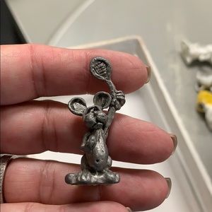 Pewter mouse playing tennis